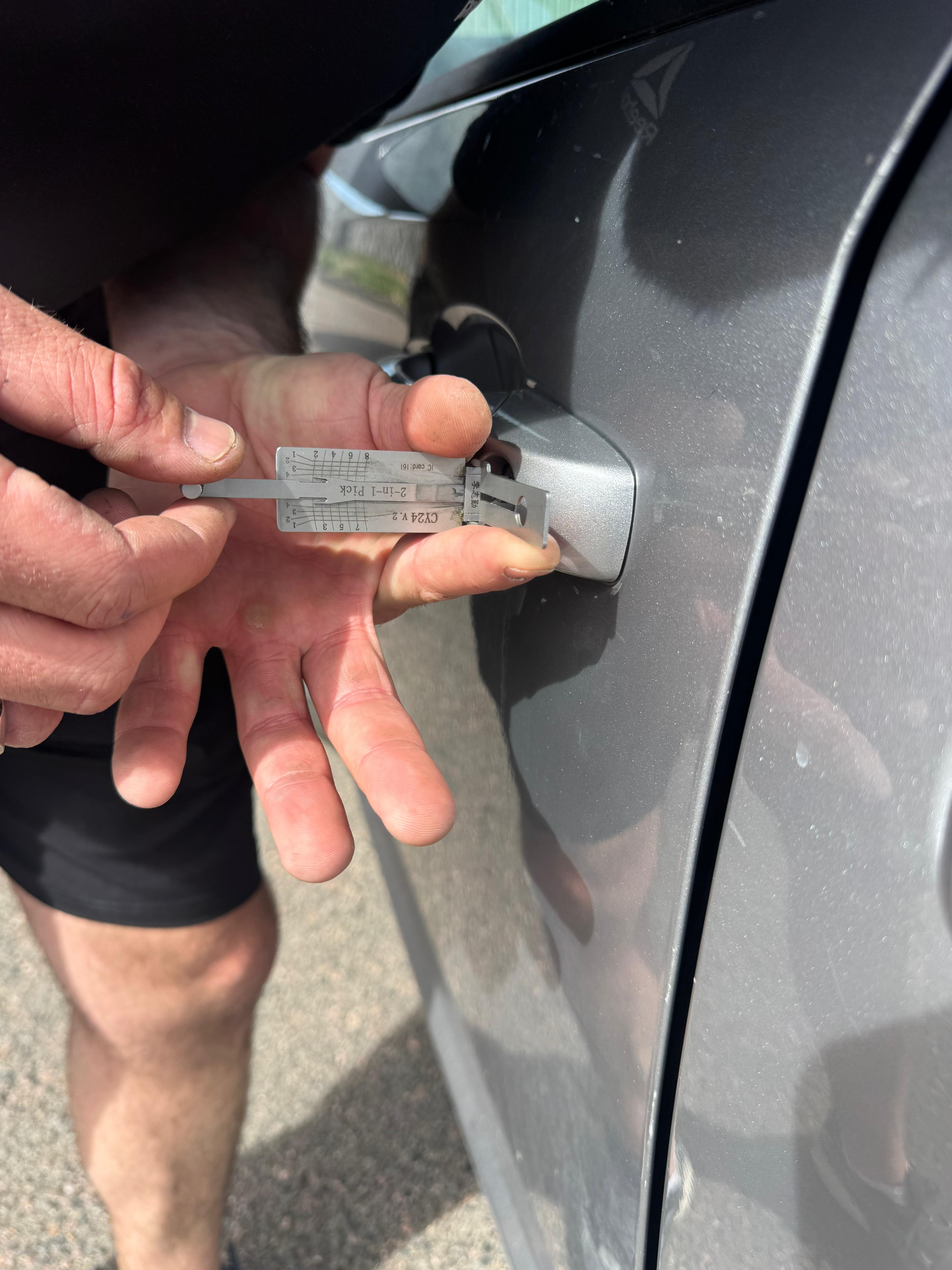 Elite Locksmiths Denver technician performing damage-free vehicle entry with a lock pick tool